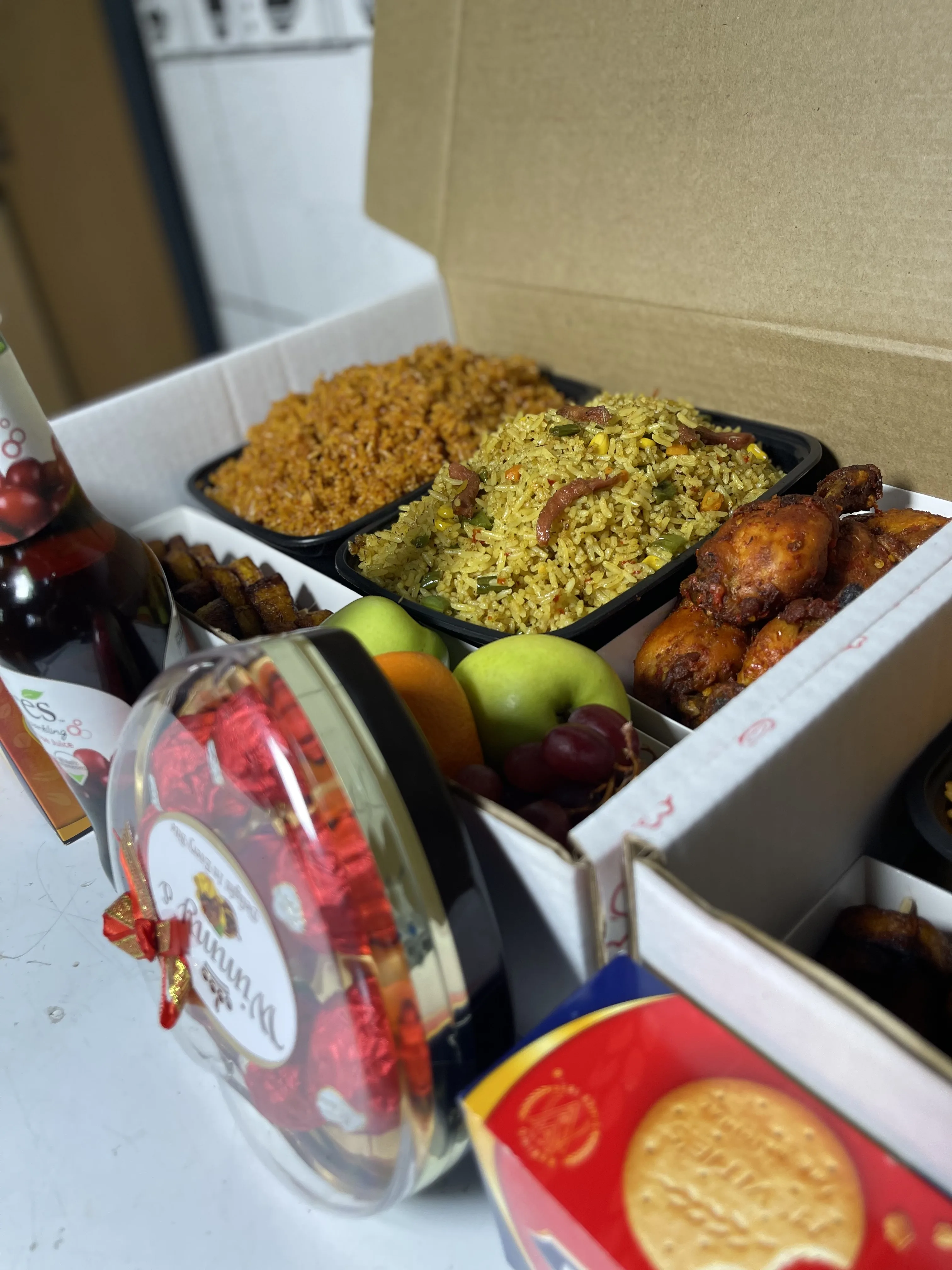 Gift food box with rice, plantain, chicken, and fruits