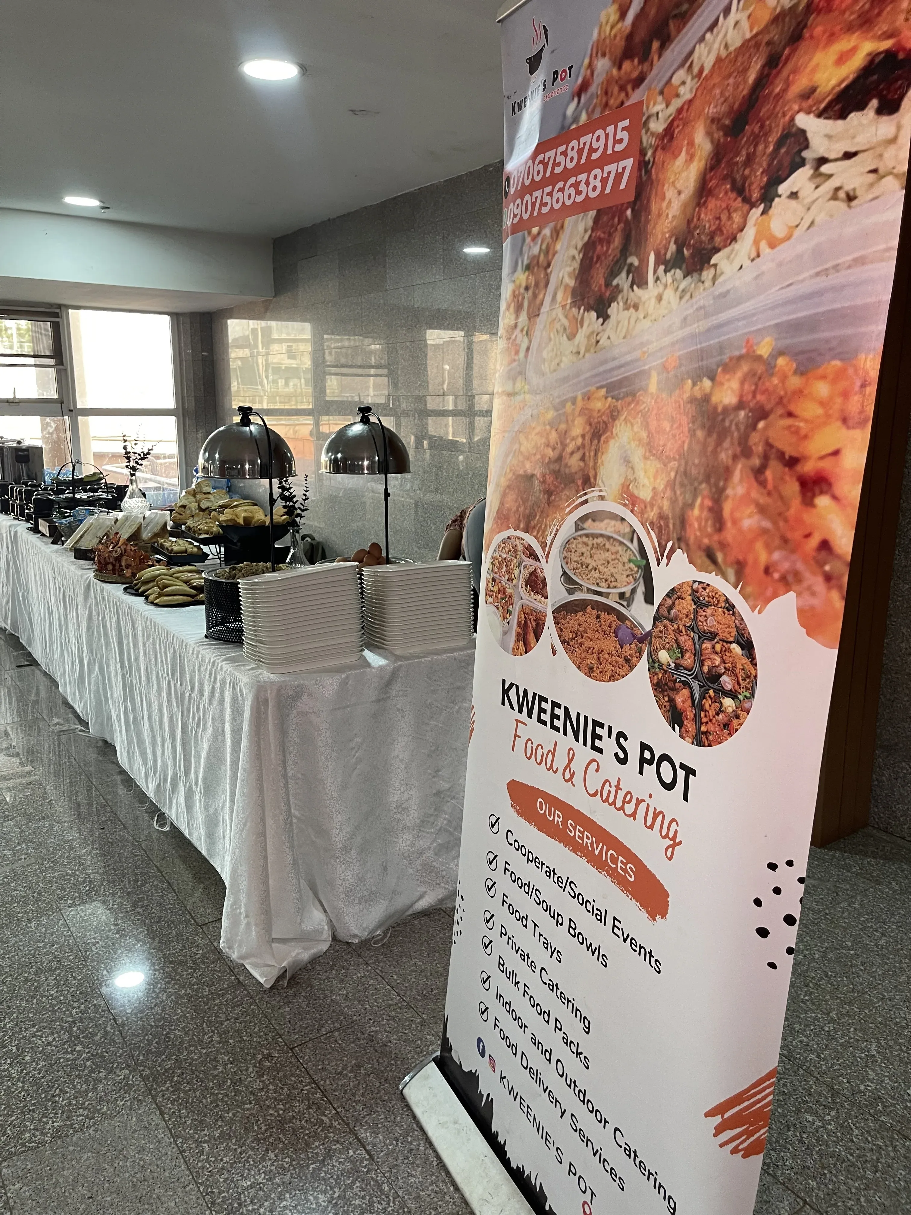 Kweenie's Pot banner at a catering event setup